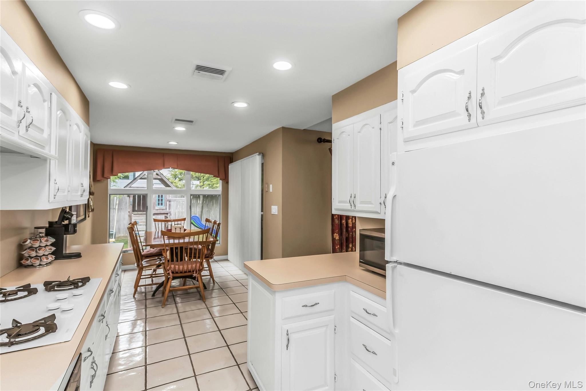 57 Joyce Road Plainview, NY 11803 - Photo 9 of 20 a kitchen with a sink appliances and cabinets