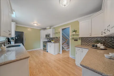 a kitchen with a sink stove and refrigerator