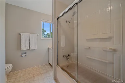 a bathroom with a shower and a toilet