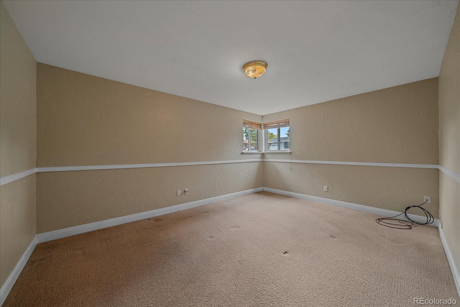 6072 Pierson Court Arvada, CO 80004 - Photo 20 of 31 an empty room with a empty space and windows