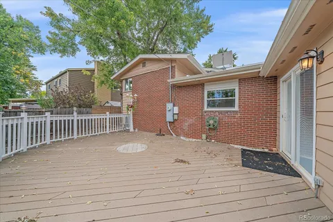 a terrace of a house with wooden floor and fence