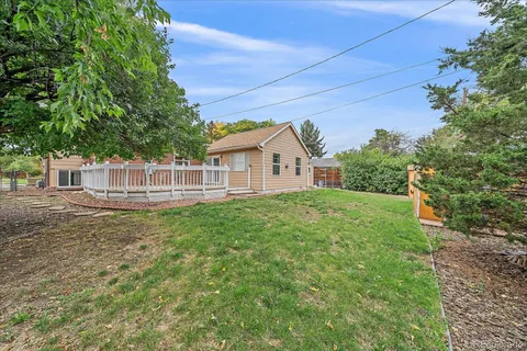 a view of a house with a yard and sitting area