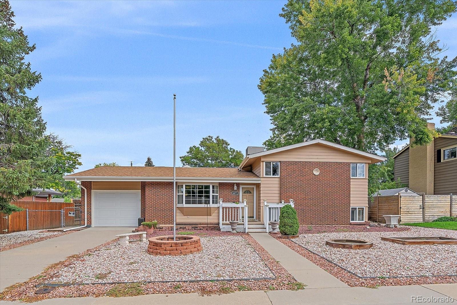 6072 Pierson Court Arvada, CO 80004 - Photo 31 of 31 a front view of a house with a yard