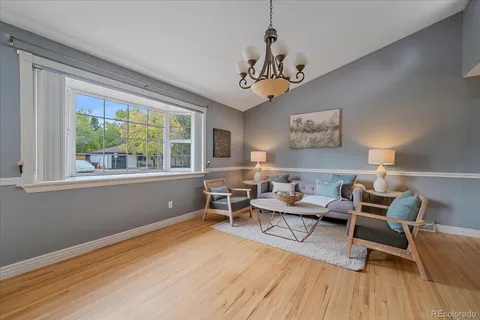 a living room with furniture and a chandelier