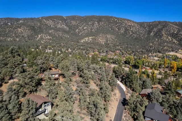an aerial view of a residential houses with parking space