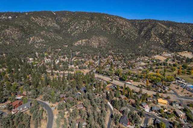 a view of a large building with mountains in the background