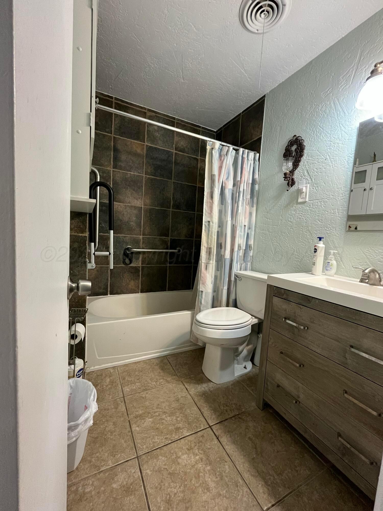 5105 James Avenue Amarillo, TX 79106 - Photo 13 of 21 a bathroom with a sink toilet and shower