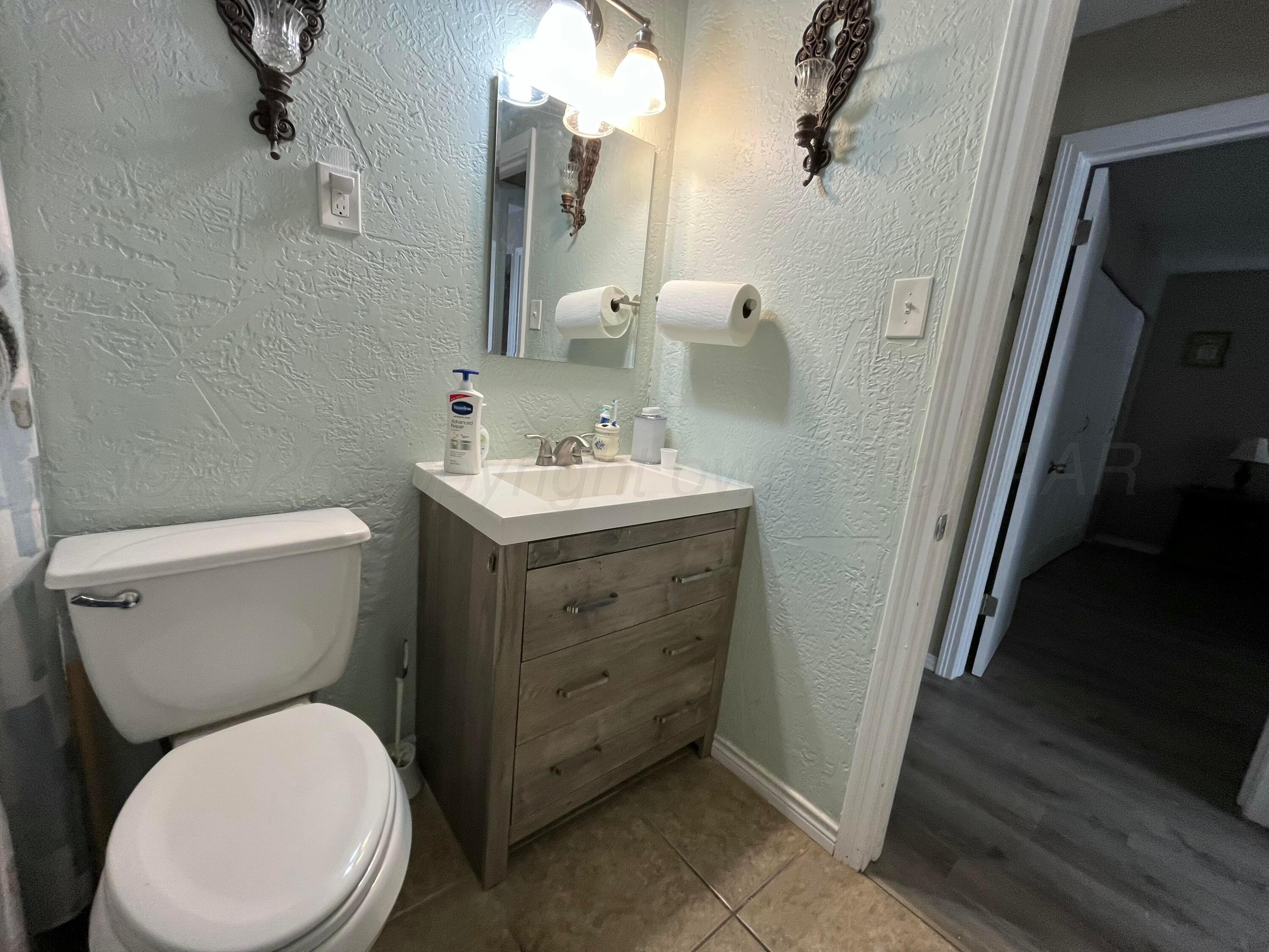 5105 James Avenue Amarillo, TX 79106 - Photo 14 of 21 a white toilet sitting next to a bathroom sink