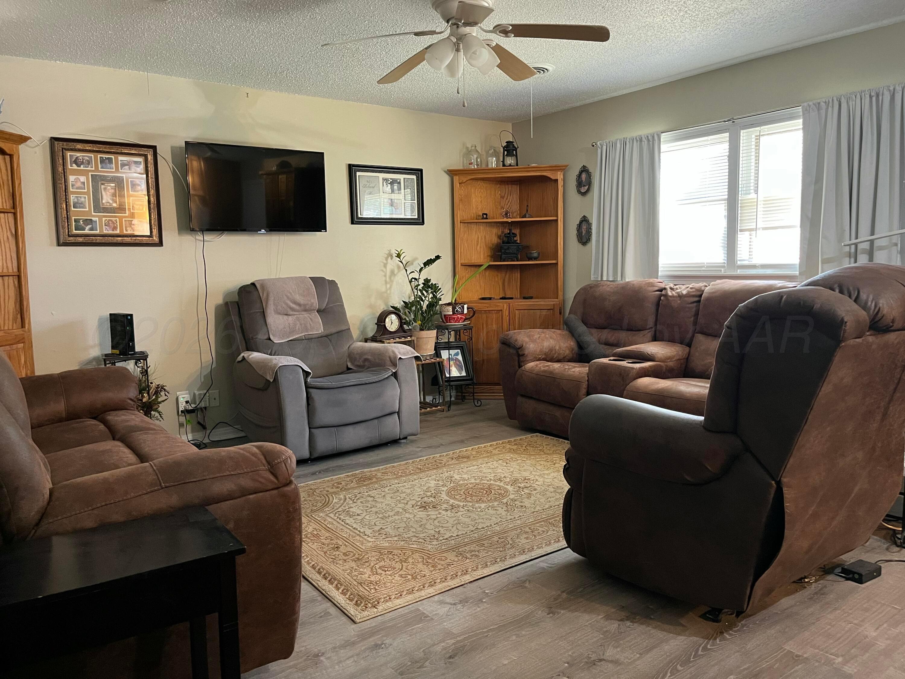 5105 James Avenue Amarillo, TX 79106 - Photo 2 of 21 a living room with furniture and a flat screen tv