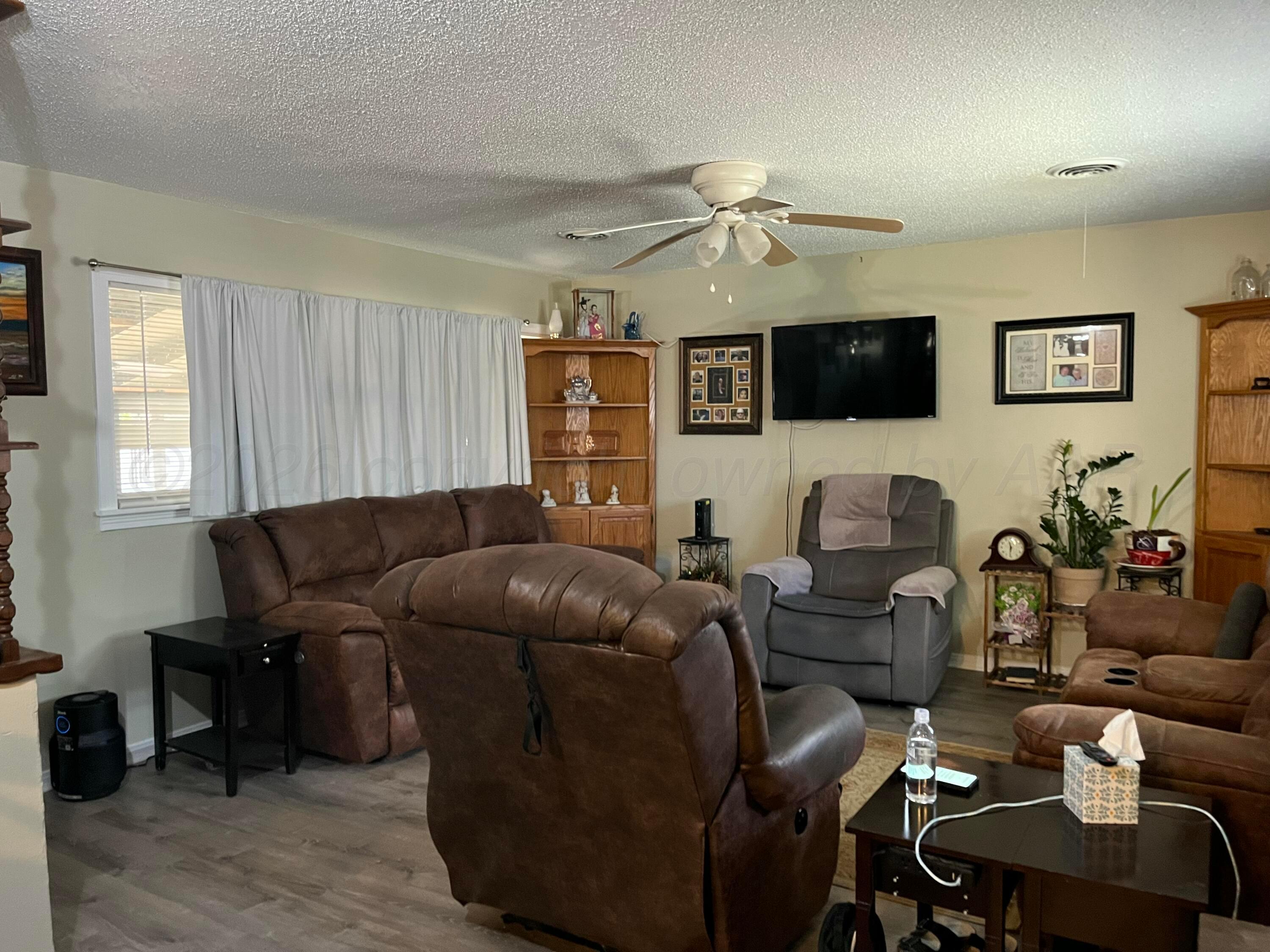 5105 James Avenue Amarillo, TX 79106 - Photo 3 of 21 a living room with furniture a flat screen tv and a window