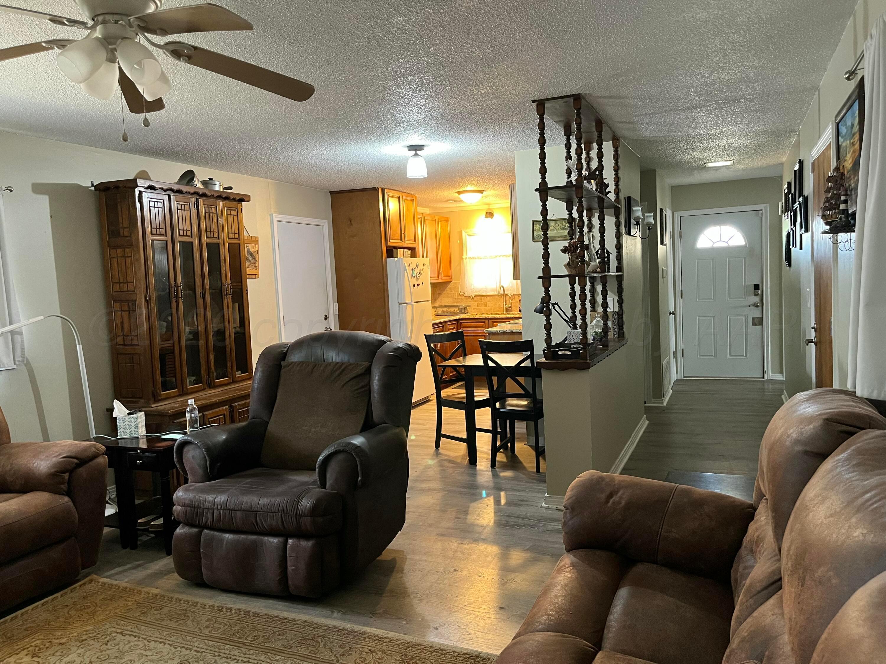 5105 James Avenue Amarillo, TX 79106 - Photo 4 of 21 a living room with furniture a ceiling fan and a rug