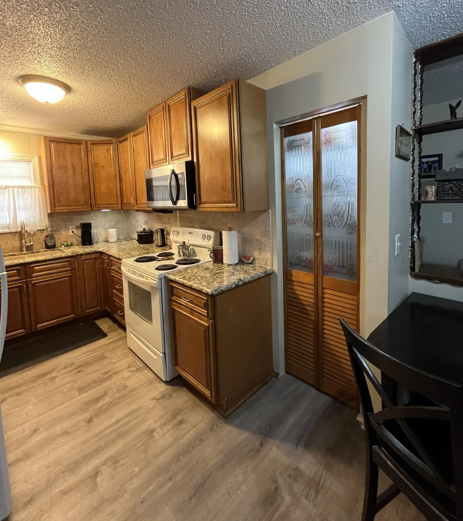 5105 James Avenue Amarillo, TX 79106 - Photo 7 of 21 a kitchen with a sink stove top oven and refrigerator