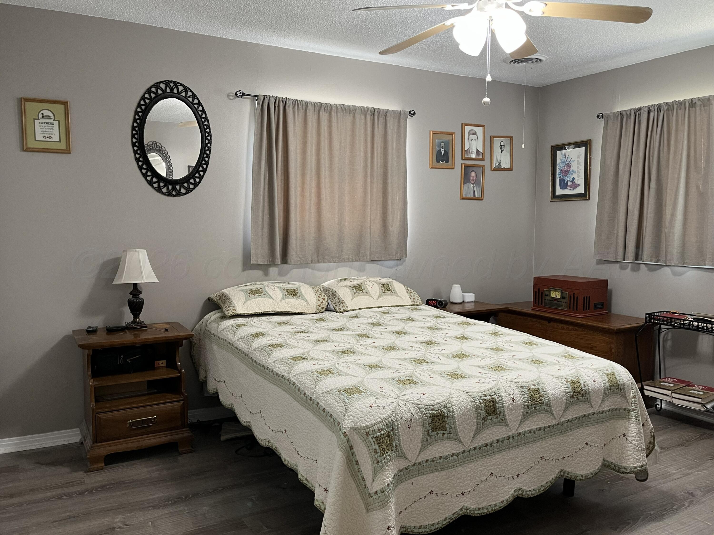 5105 James Avenue Amarillo, TX 79106 - Photo 9 of 21 a bedroom with a bed and a chandelier
