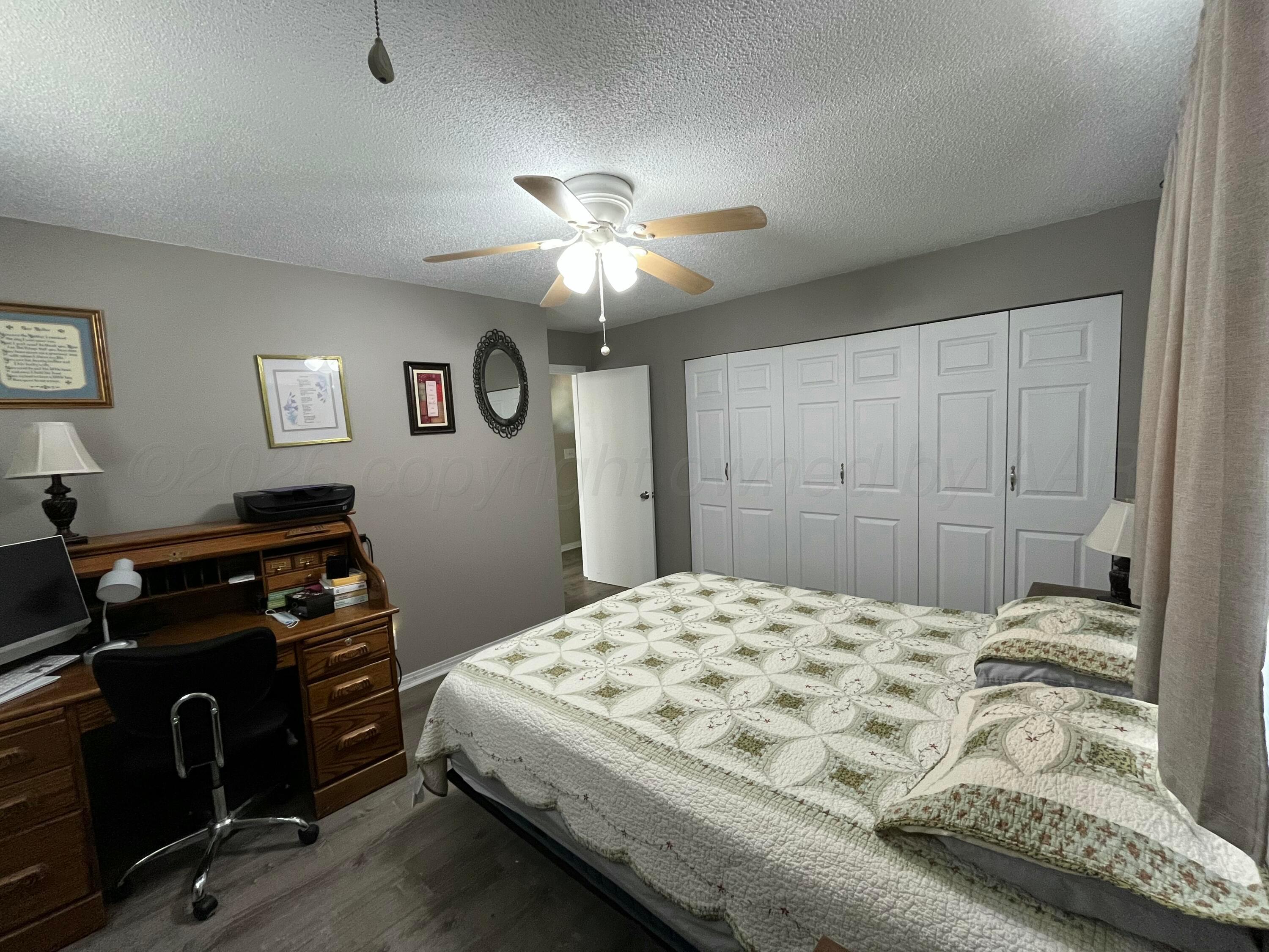 5105 James Avenue Amarillo, TX 79106 - Photo 10 of 21 a bedroom with a bed and a chandelier
