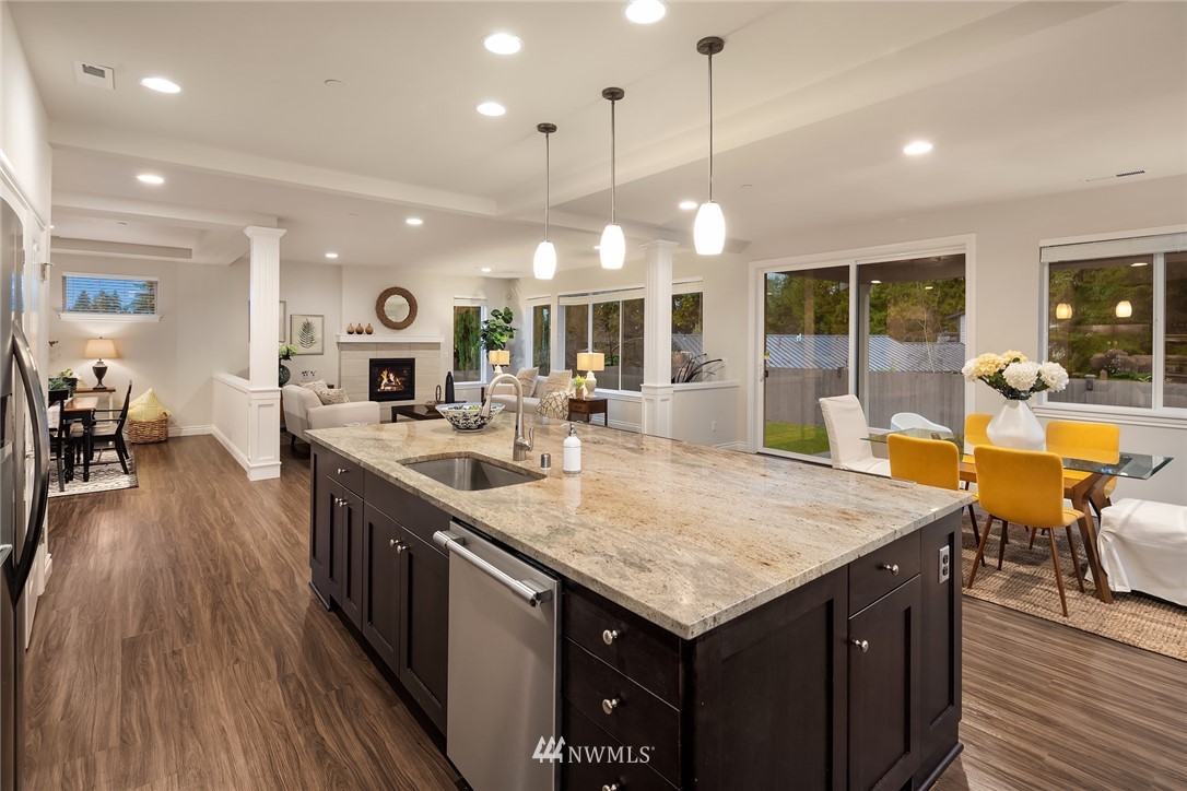 307 221st Place Southwest Bothell, WA 98021 - Photo 12 of 29 a kitchen with a stove center island wooden floor and a living room view