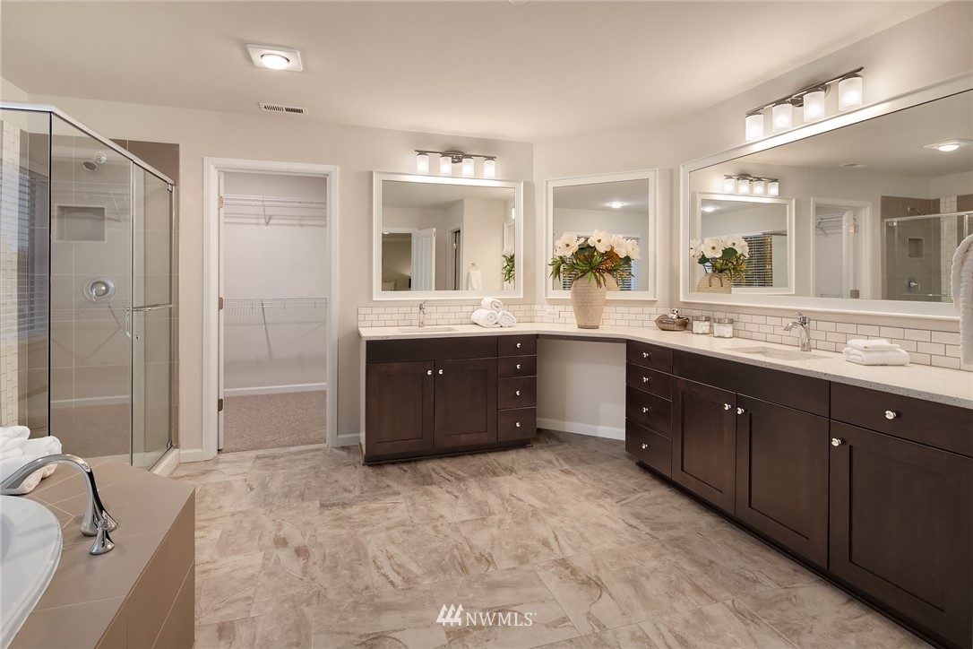 307 221st Place Southwest Bothell, WA 98021 - Photo 20 of 29 a spacious bathroom with a granite countertop double vanity and mirror