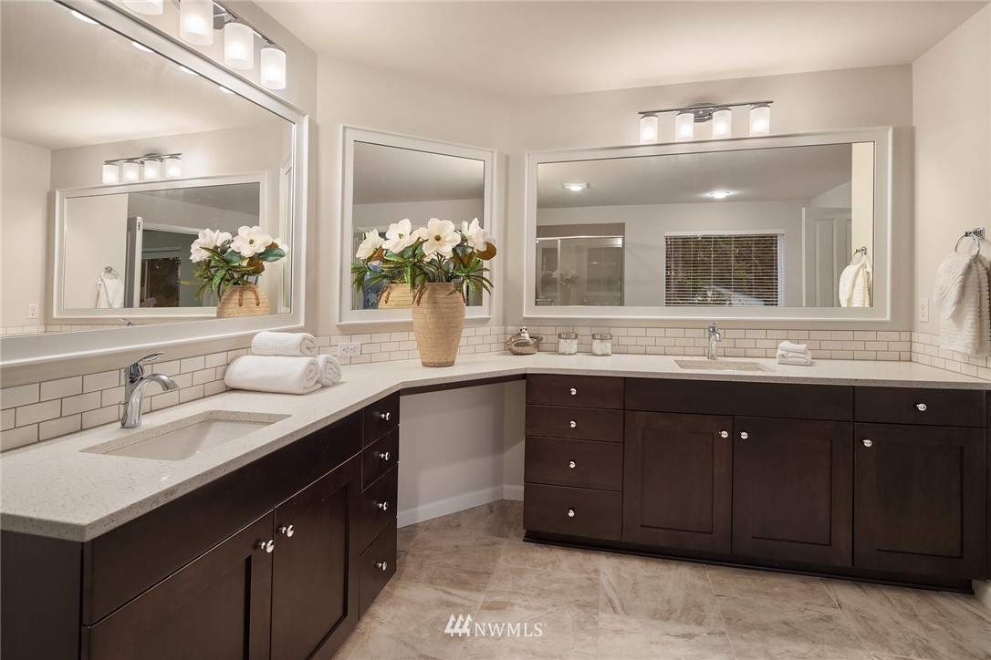 307 221st Place Southwest Bothell, WA 98021 - Photo 21 of 29 a bathroom with a granite countertop double vanity sink and a mirror