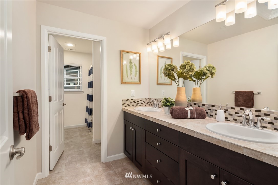307 221st Place Southwest Bothell, WA 98021 - Photo 23 of 29 a bathroom with a double vanity sink shower and a mirror