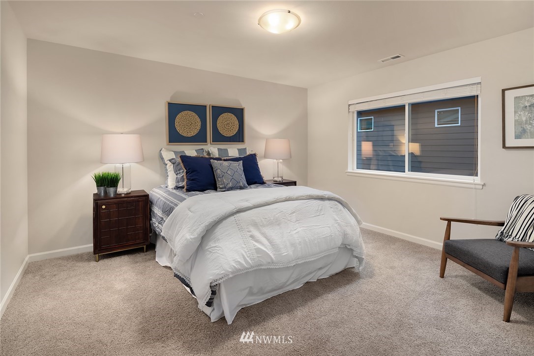 307 221st Place Southwest Bothell, WA 98021 - Photo 24 of 29 a bedroom with a bed and a painting on the wall