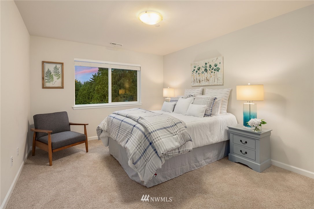 307 221st Place Southwest Bothell, WA 98021 - Photo 25 of 29 a spacious bedroom with a bed and a couch