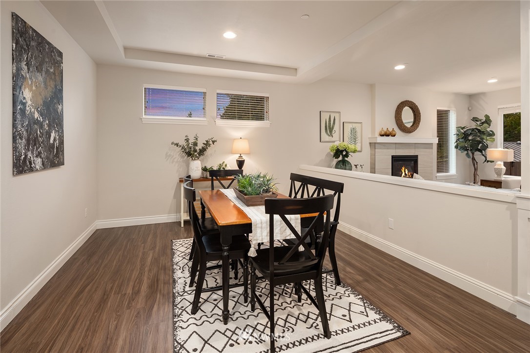 307 221st Place Southwest Bothell, WA 98021 - Photo 4 of 29 a view of a dining room with furniture and wooden floor