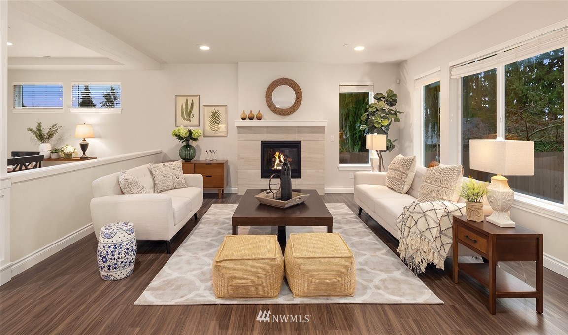307 221st Place Southwest Bothell, WA 98021 - Photo 5 of 29 a living room with furniture a fireplace and a table