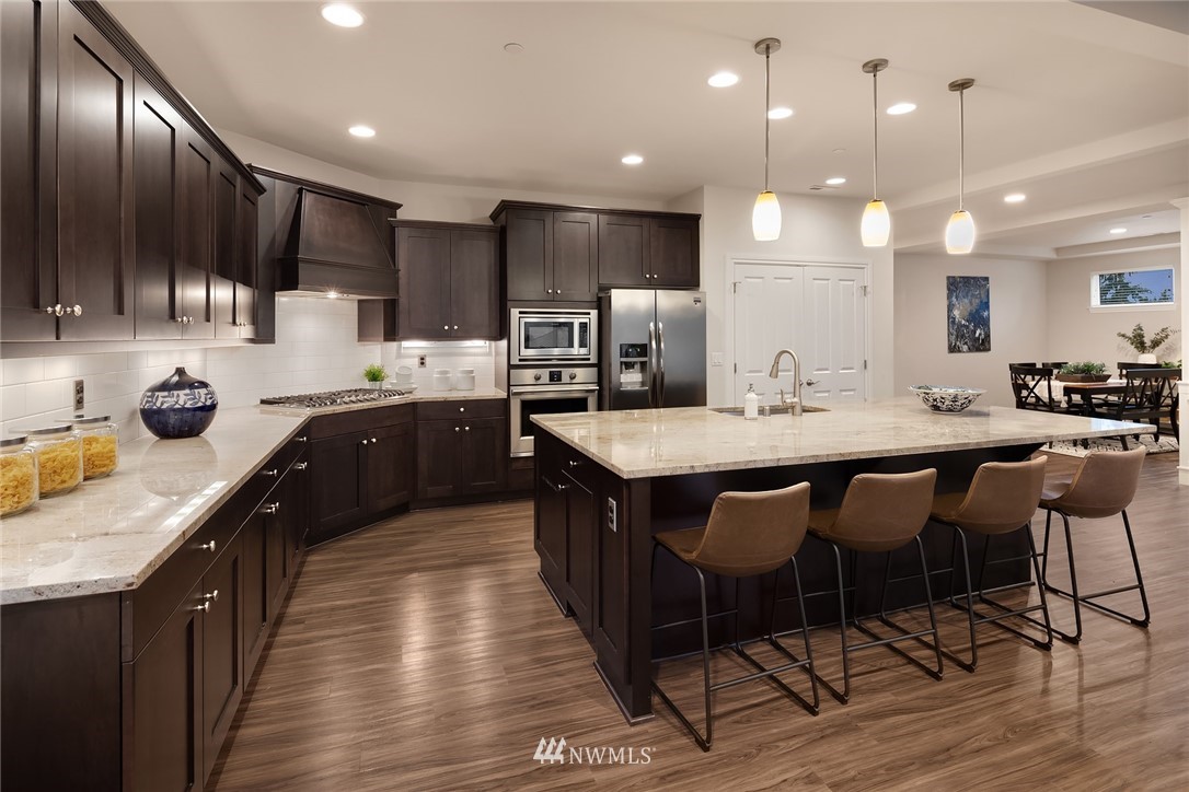307 221st Place Southwest Bothell, WA 98021 - Photo 8 of 29 a large kitchen with lots of counter space a sink and chairs