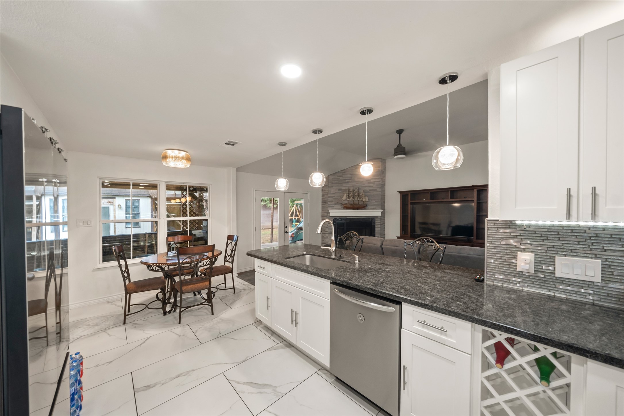 25434 Cedar Lane Splendora, TX 77372 - Photo 16 of 29 a large kitchen with granite countertop a sink and chairs