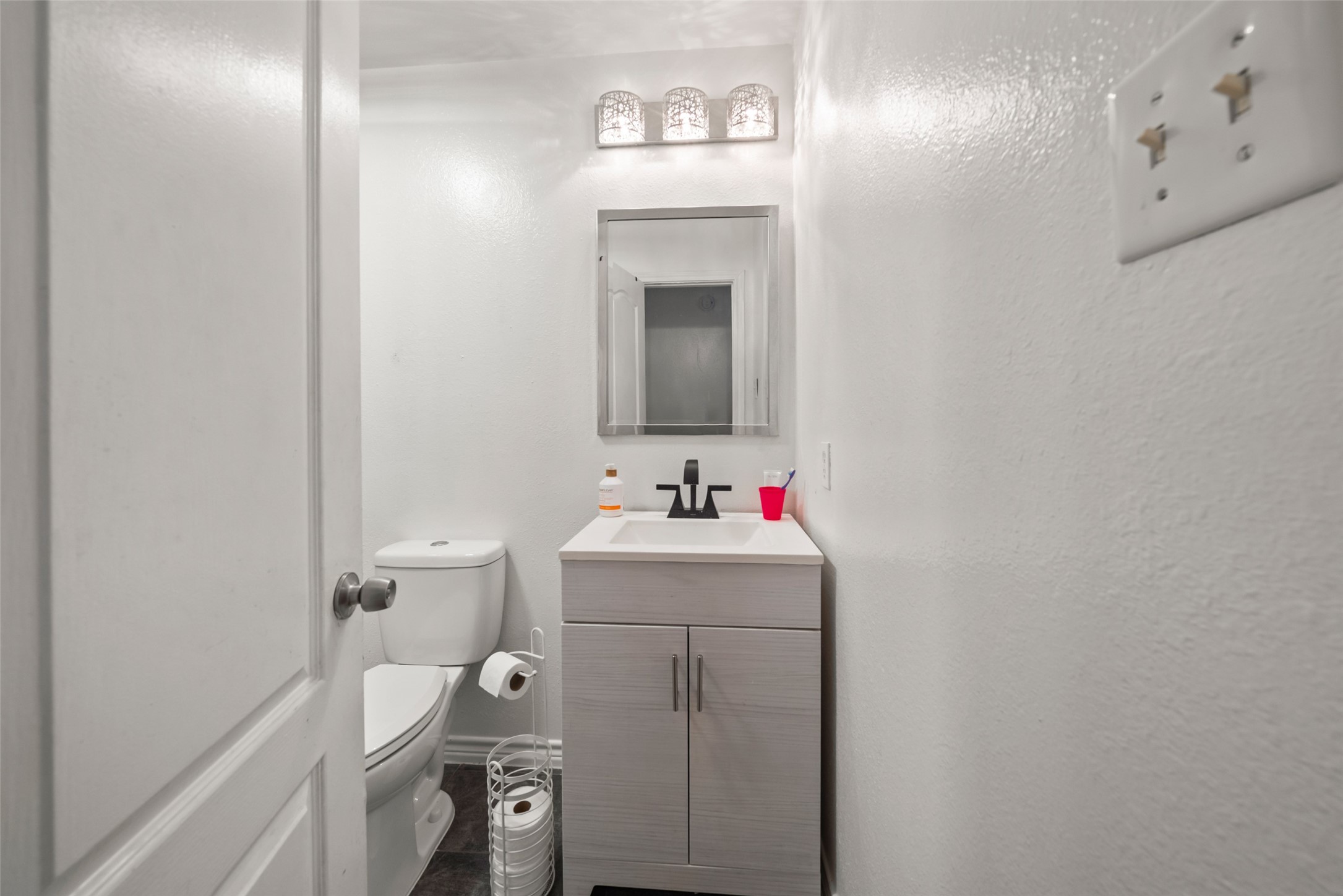 25434 Cedar Lane Splendora, TX 77372 - Photo 19 of 29 a bathroom with a sink vanity mirror and toilet