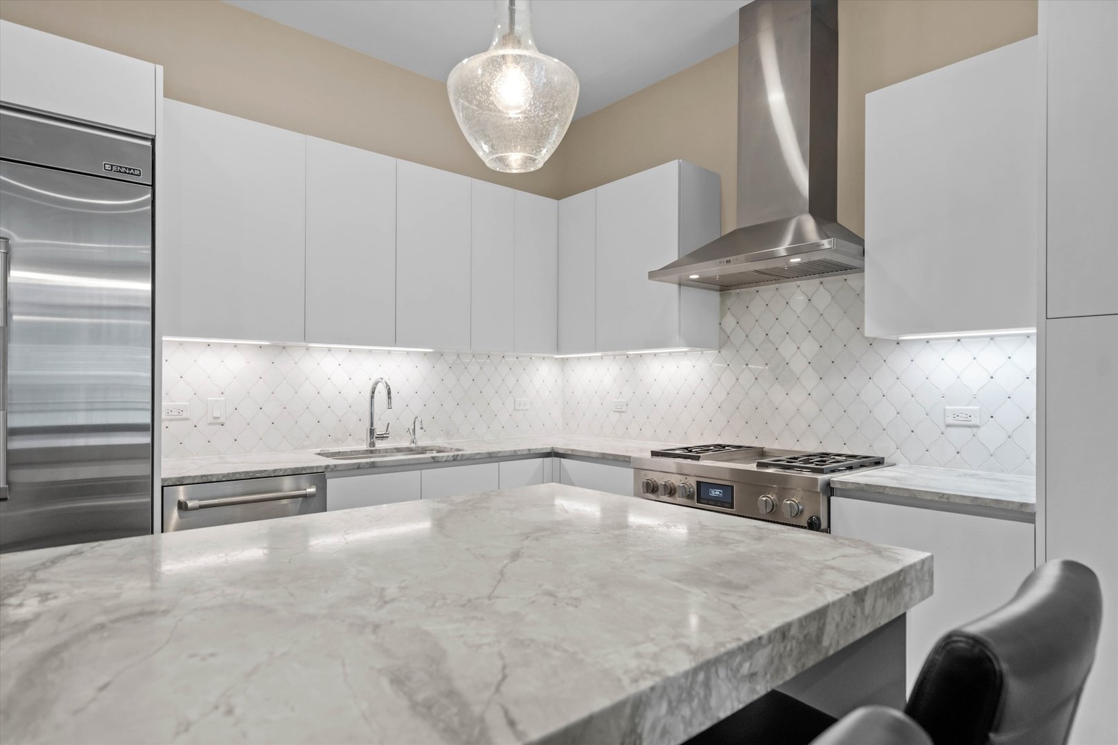 31 North Aberdeen Street, Unit 2S Chicago, IL 60607 - Photo 11 of 33 a kitchen with stainless steel appliances granite countertop a sink a stove and a refrigerator