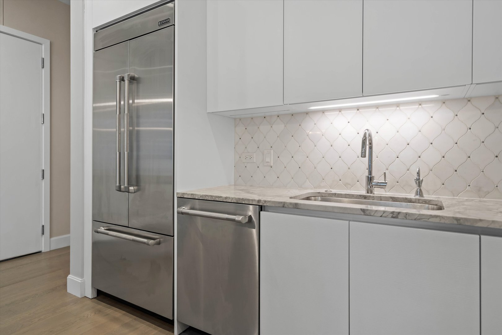 31 North Aberdeen Street, Unit 2S Chicago, IL 60607 - Photo 12 of 33 a kitchen with stainless steel appliances granite countertop white cabinets and a refrigerator