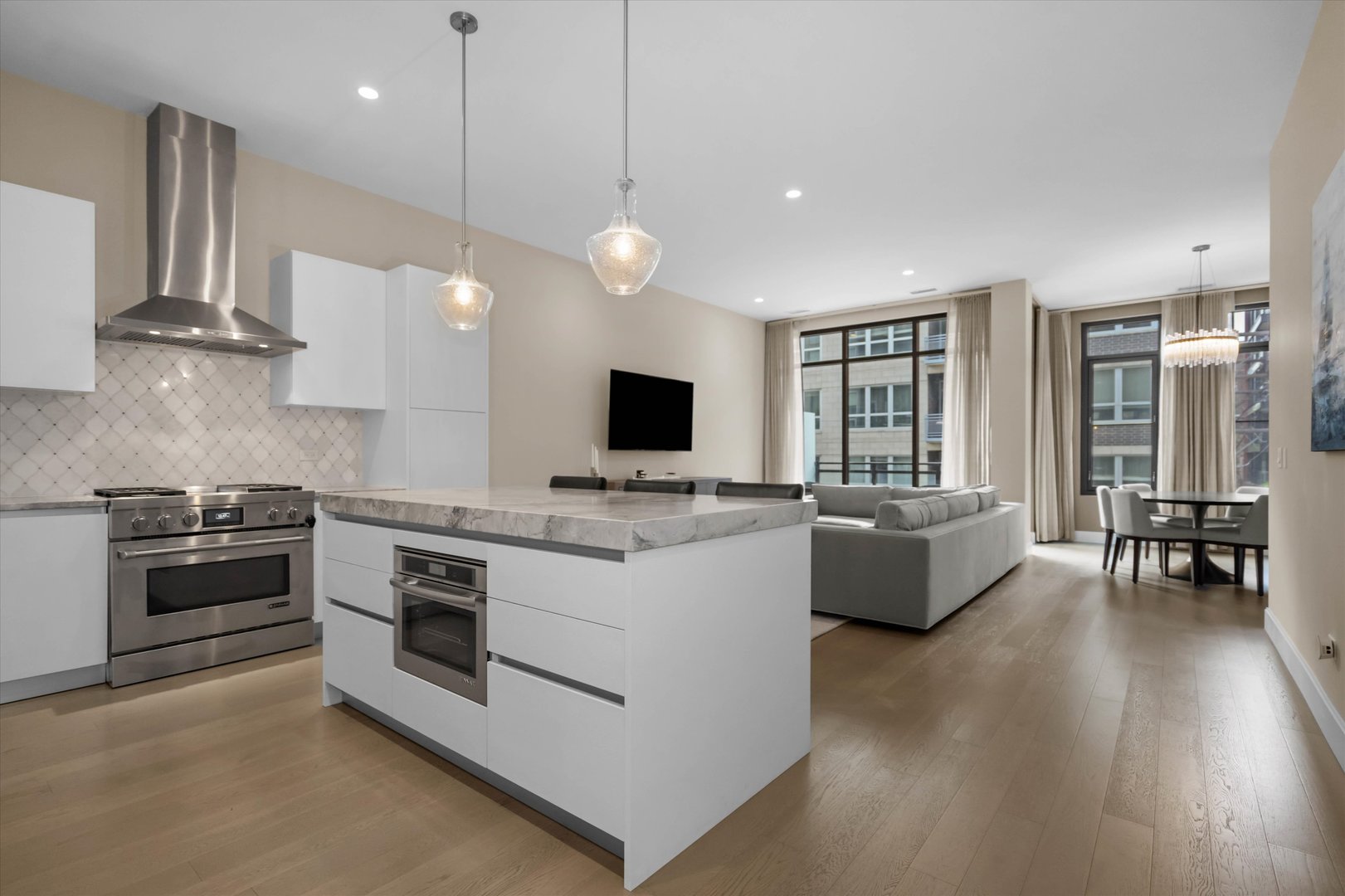 31 North Aberdeen Street, Unit 2S Chicago, IL 60607 - Photo 13 of 33 a large kitchen with stainless steel appliances granite countertop a stove and a wooden floors