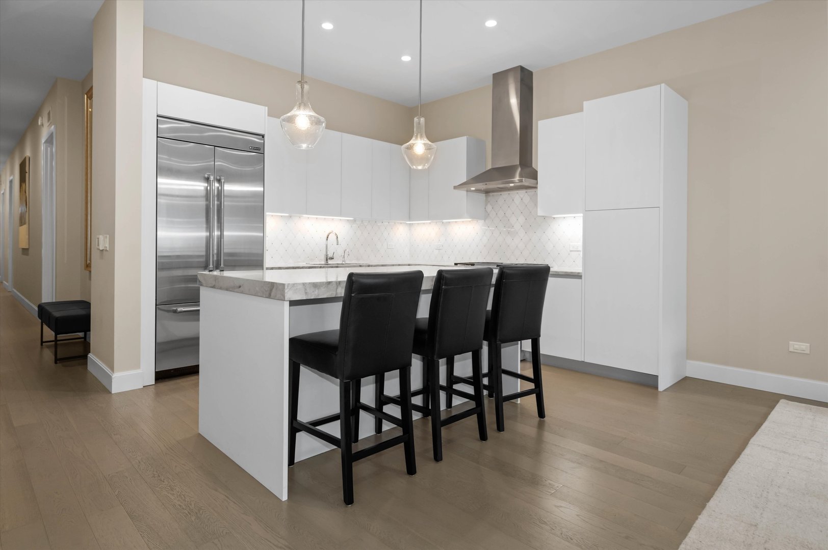 31 North Aberdeen Street, Unit 2S Chicago, IL 60607 - Photo 8 of 33 a kitchen with stainless steel appliances a dining table chairs and wooden floor
