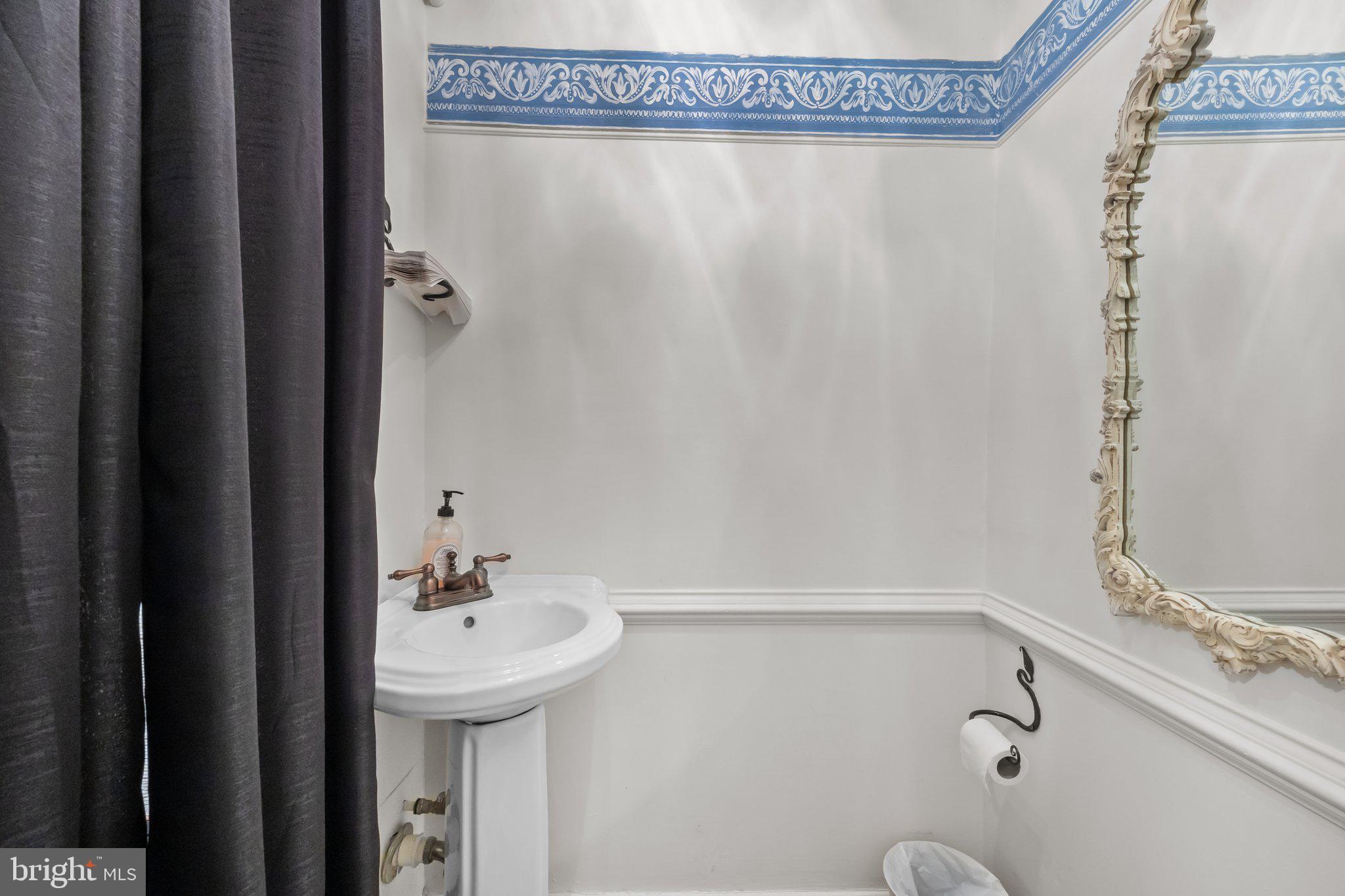 111 South State Street Newtown, PA 18940 - Photo 17 of 37 a bathroom with a sink and a mirror