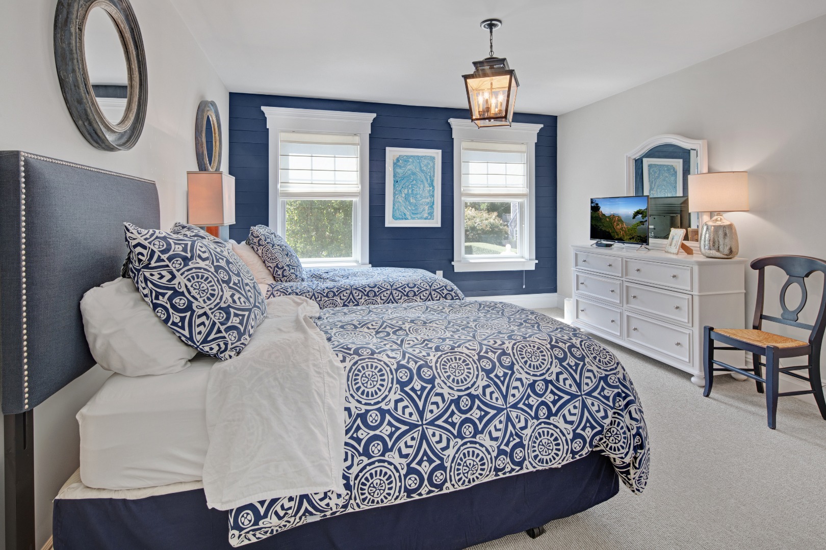 53 Pinehurst Road Edgartown, MA 02539 - Photo 16 of 26 a bedroom with a bed a mirror on dresser and a window