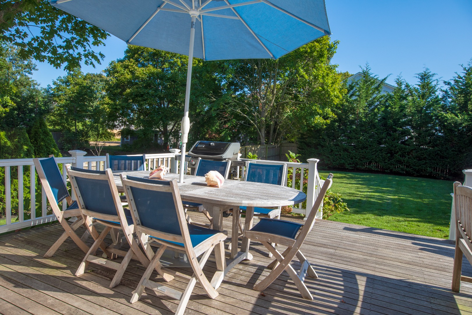 53 Pinehurst Road Edgartown, MA 02539 - Photo 4 of 26 a view of a patio with table and chairs under an umbrella