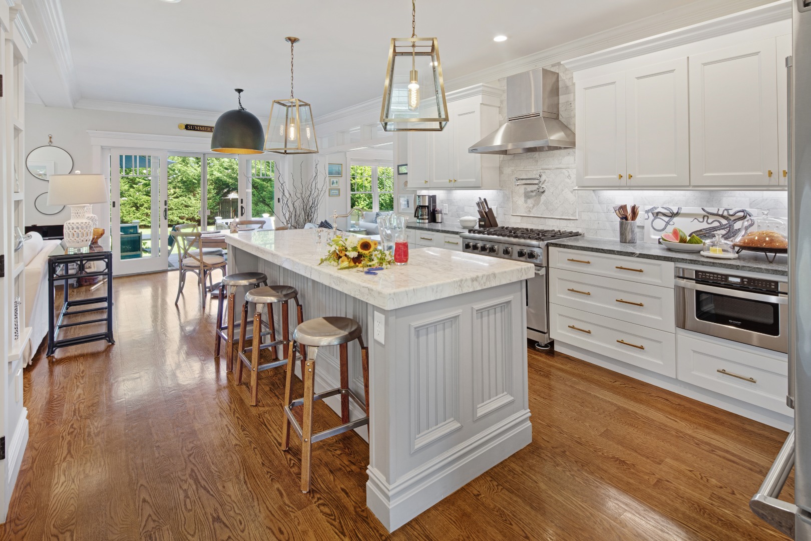 53 Pinehurst Road Edgartown, MA 02539 - Photo 8 of 26 a kitchen with stainless steel appliances a stove a sink a refrigerator and a dining table with wooden floor