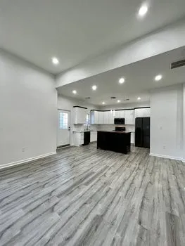 a view of kitchen and kitchen island wooden floor