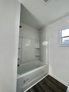 a bathroom with a bathtub and shower