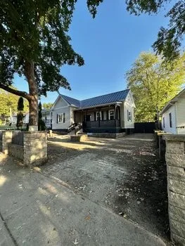 a view of house with outdoor space and swimming pool