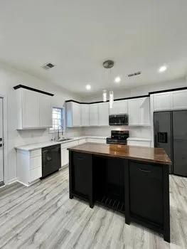 a kitchen with stainless steel appliances granite countertop a sink and cabinets