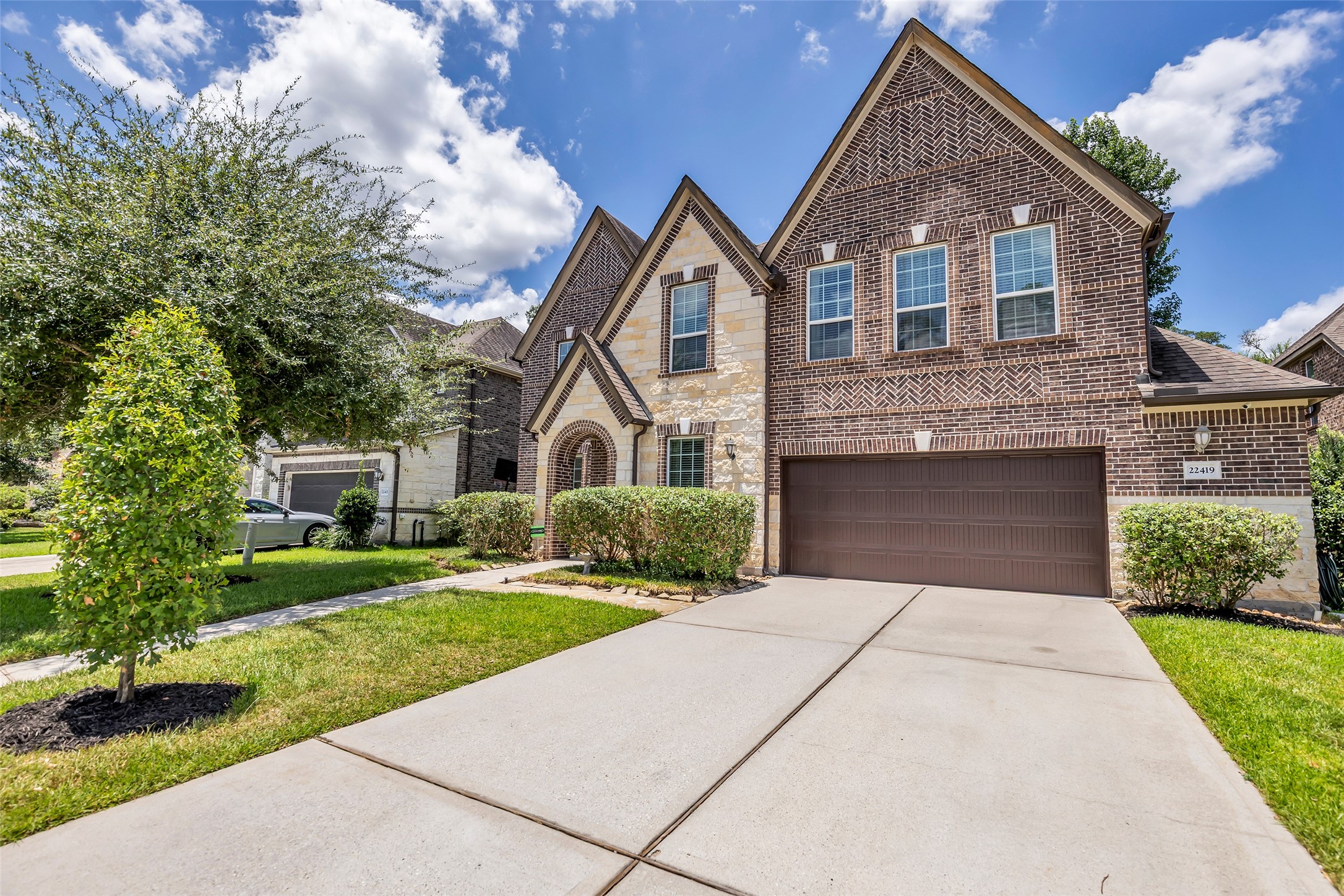 22419 Sawmill Ranch Drive Spring, TX 77389 - Photo 2 of 45 This home's striking brick-and-stone façade, soaring gables, and inviting arched entry delight the senses.
