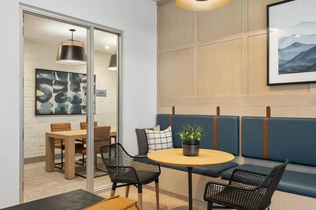 a dining room with furniture and a floor to ceiling window