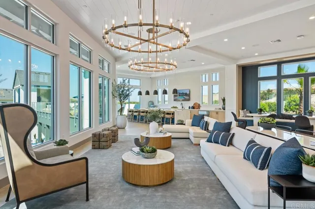a living room with furniture chandelier and a large window