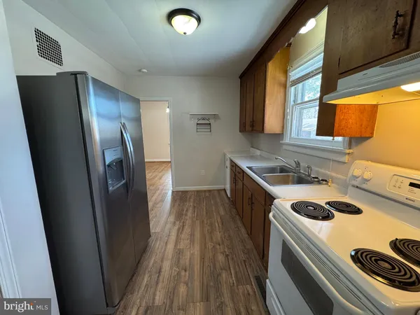 a kitchen with metallic refrigerator freezer and a dishwasher
