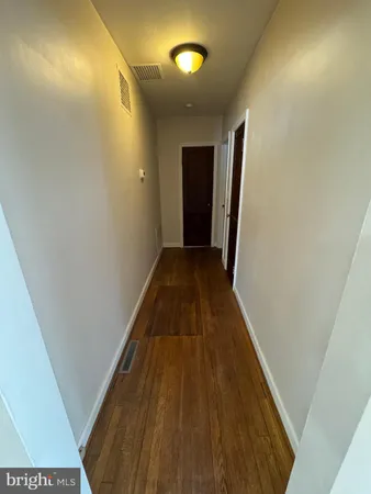 a white toilet sitting next to a bathroom sink and a mirror