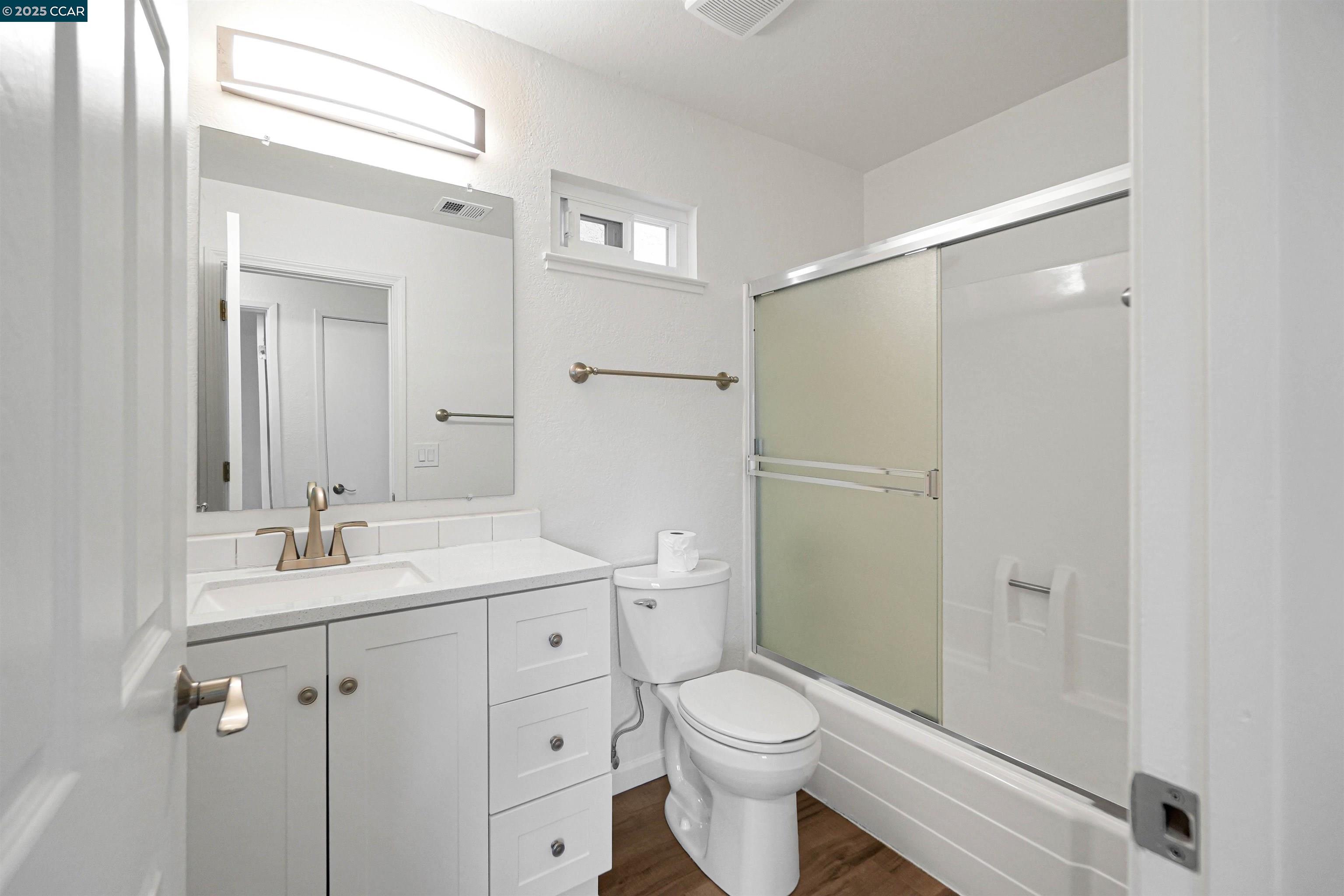 3712 Willow Pass Road, Unit 31 Concord, CA 94519 - Photo 9 of 17 a bathroom with a granite countertop sink toilet and shower
