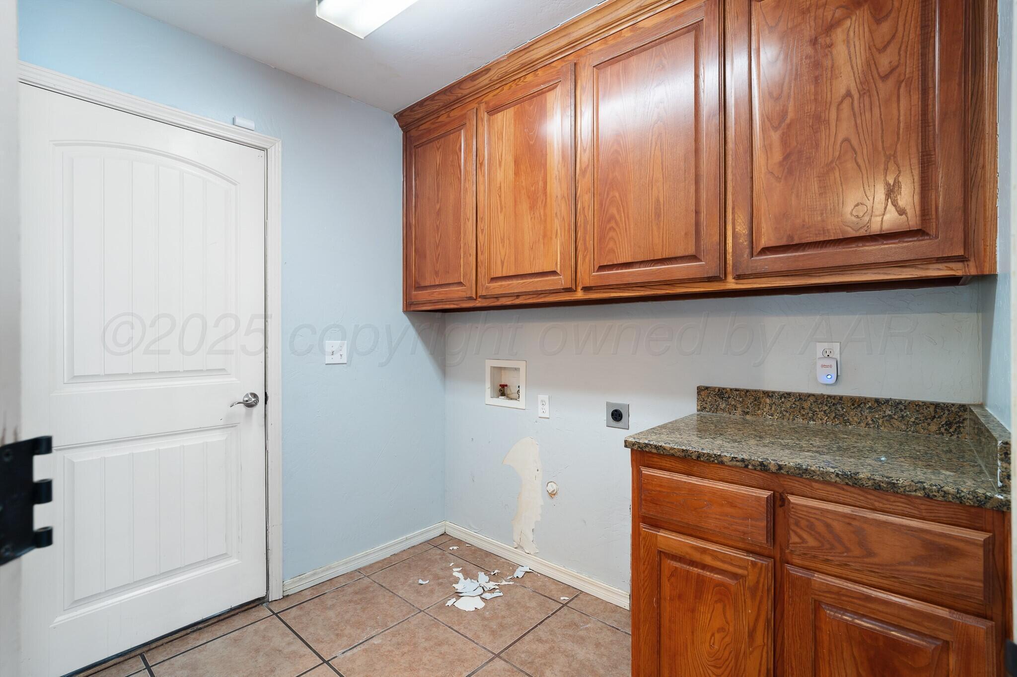 6302 Academy Drive Amarillo, TX 79119 - Photo 17 of 19 a kitchen with granite countertop cabinets and black appliances