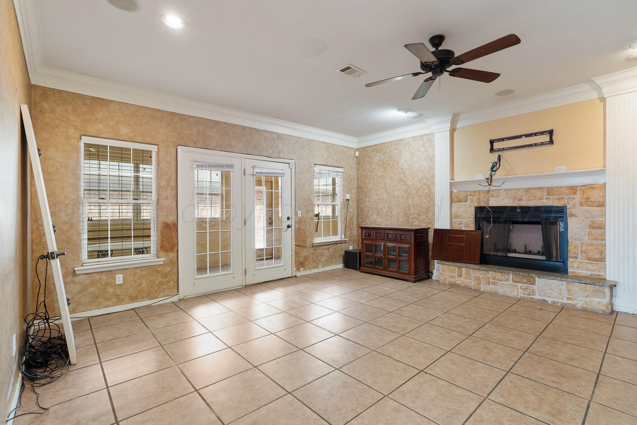6302 Academy Drive Amarillo, TX 79119 - Photo 8 of 19 a living room with furniture and a fireplace