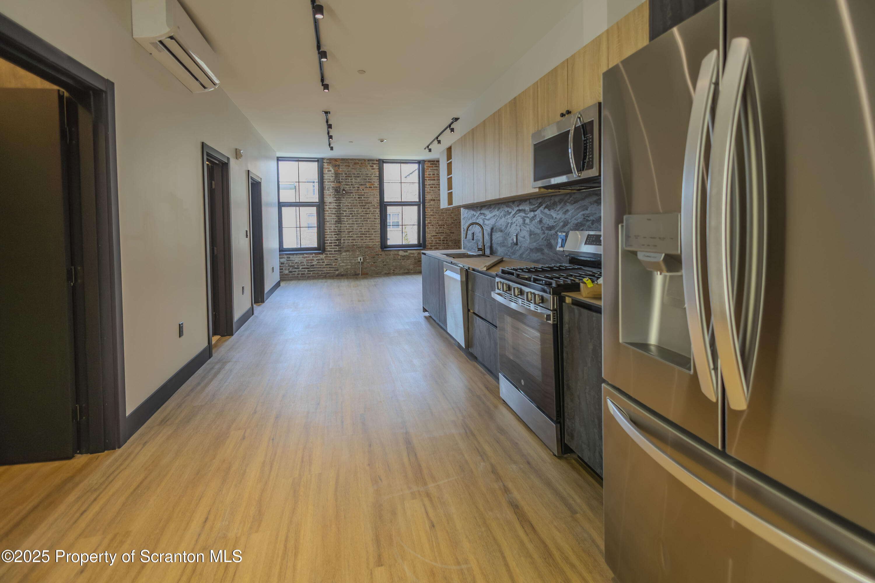 117 Penn Avenue Scranton, PA 18503 - Photo 11 of 25 a kitchen with stainless steel appliances granite countertop a refrigerator a stove and a wooden floors